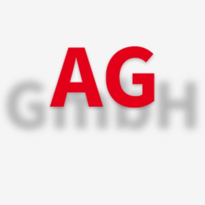 The image shows the red letters AG in sharp focus over blurred gray letters GmbH on a light background.